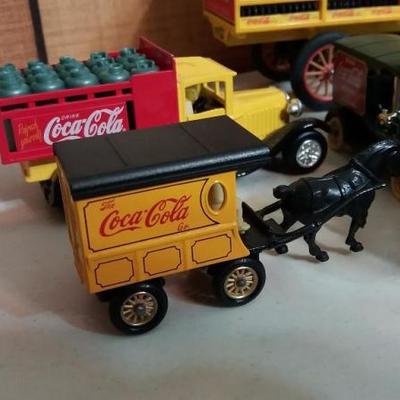 Seven (7) Lledo small cars with Coca-Cola name on side, two (2) other Siku trucks and one (1) early 