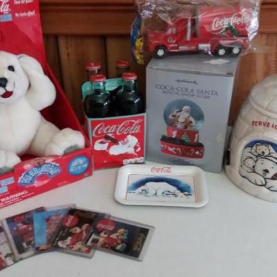 Variety of Coca-Cola items - White Polar bear with light and sound in red hat, trading cards for Coc