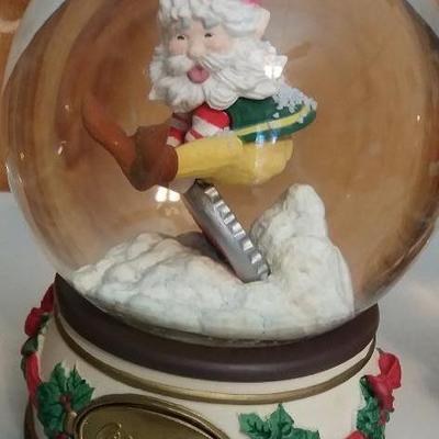 Three (3) snow globes - Santa jumping over bottle cap, Santa drinking a Coke and Santa carrying pres