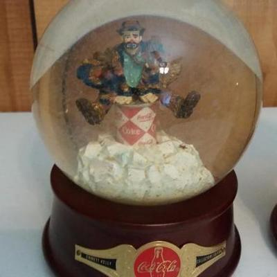 Two (2) Emmitt Kelly's snow globes/music boxes.