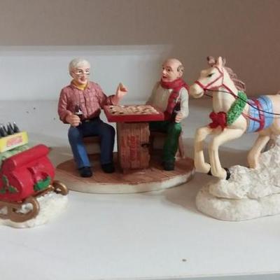 Lot of three (3) Characters - man push woman in sleigh and man and woman in horse drawn sleigh.