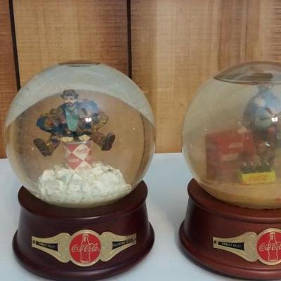 Two (2) Emmitt Kelly's snow globes/music boxes.