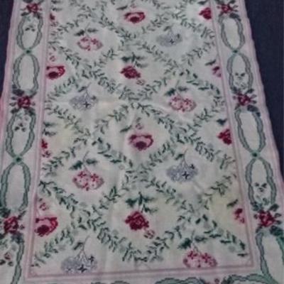 $40.00 - CREWEL WORK WOOL RUG, OFF WHITE FIELD WITH RED FLORALS AND GREEN LEAVES, GOOD CONDITION WITH SOME SPOTTING