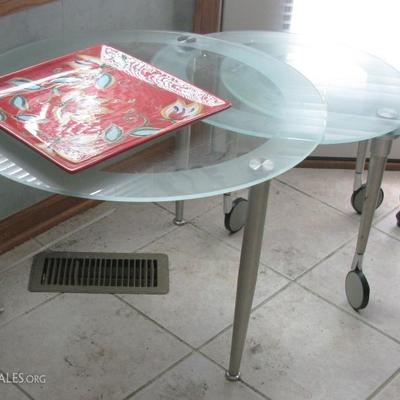 cool modern table that opens to a 3 top table and casters