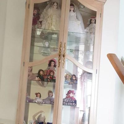 large curio filled with dolls