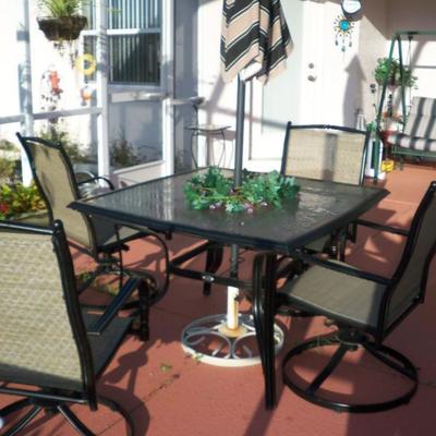 Patio table with 4 swivel chairs and umbrella