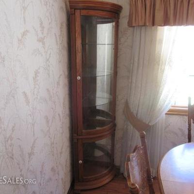 Corner curio with rounded glass front doors
