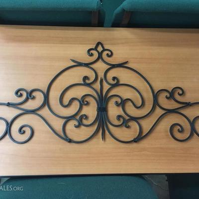 Black metal scrolling pediment