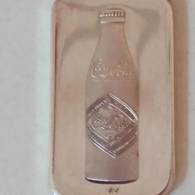 Sterling silver ingot embossed with Cocal-Cola antique bottle on one side, and commemorating 75th an