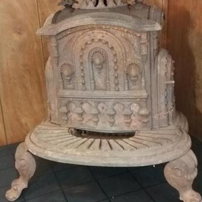 Antique cast iron stove, decorative shell motif. Made by Fuller Warren and Morrison, Troy NY.