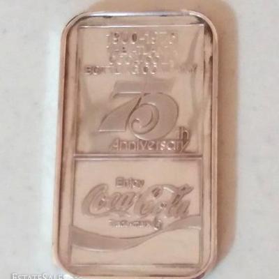 Sterling silver ingot embossed with Cocal-Cola antique bottle on one side, and commemorating 75th an