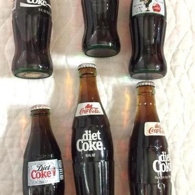 One six pack of miscellaneous Coca-Cola bottles 2 10 oz bottles of Diet Coke (return for refund), 1 