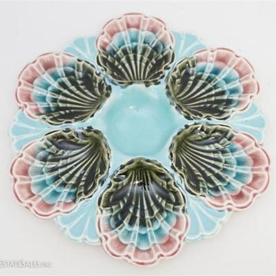 A French majolica oyster plate made by Longchamp, circa 1880-1885. A central sauce well is surrounded by six scallop edged wells. Highly...