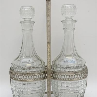 A pair of Large Vintage English Pressed Glass Decanters with Silver Plated Caddy. The bottoms are marked Made in England. In good...
