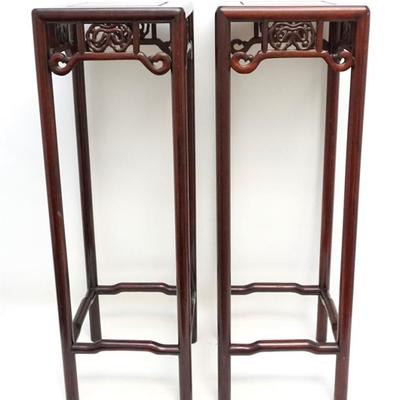 A matched pair of Chinese Elmwood Carved and Pierced Stands. Each stand measures 10