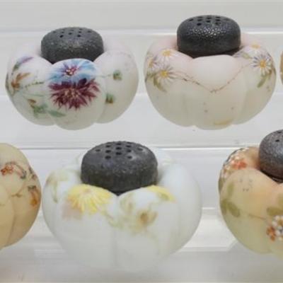 Seven 19th c. Mt. Washington Salt Shakers. All are decorated with delicate enameled raised flowers and hand painted leaves. All are the...