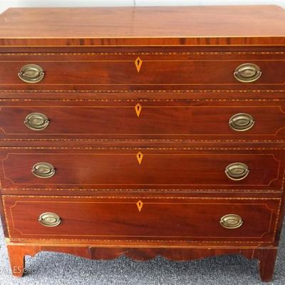 Antique American Federal satinwood inlaid cherry and mahogany chest of drawers. Having a Rectangular Top with string inlaid edge, above...