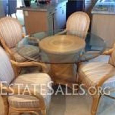
101: Rattan And Glass Dining Set  
Glass table measures 48 D x 28 H, chairs measures 22 W x 37.5 H x 22 D, bought in 1977 at a high end...