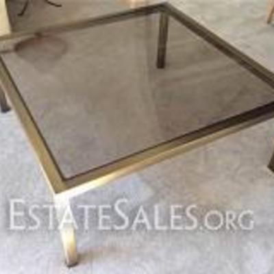 102: Brass And Glass Coffee Table
39.5 square x 16 H, brushed brass frame with tinted glass table top. Small scratch on glass top.