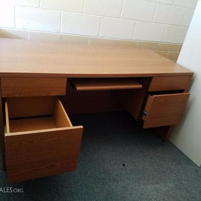 Large assortment of desks and tables