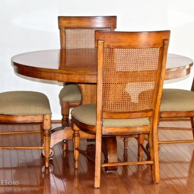 Round dining table with 6 chairs (4 shown) - table has two leaves to make an oval to seat 6