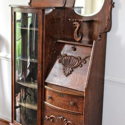 Antique oak secretary with pigeon hole storage, curved glass, unique mirrors, and wonderful decorative elements.