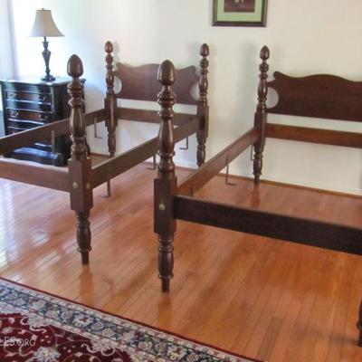 Pair of antique twin bed frames with acorn finials in walnut.
