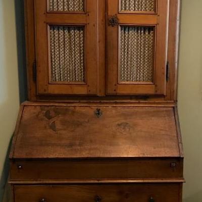 Generational antique drop down secretary desk and book cabinet with a secret compartment and chicken wire doors. With key for locks.