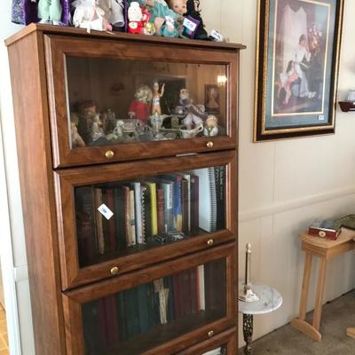 GLASS FRONT BOOK SHELF MADE OF WOOD, SOME BOOKS