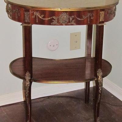19th Century French Kingwood ormolu mounted kidney shaped side table with a center lower tier. The  parquetry top and lower tier is...