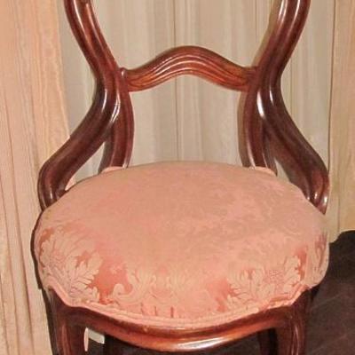 A Rococo Revival-Style Side Chair. Balloon-back with Curved Braces, Cabriole Front Legs and Flared Back Legs.  The Rounded Seat is...