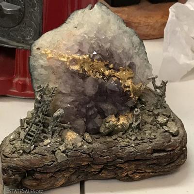 Amethyst geode with tiny pewter miner figurines depicting gold mining