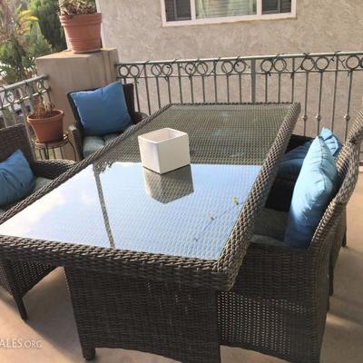 Brown wicker patio table.  Integrity Estate Sales