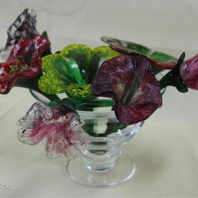 Glass floral arrangement in glass vase, flowers  are of  various heights. Whole arrangement  measures  10