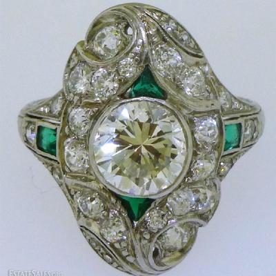 This is a stunning platinum antique diamond & emerald dinner ring. The shank of the ring is a size 6.75, measures approx. 1.65mm at the...