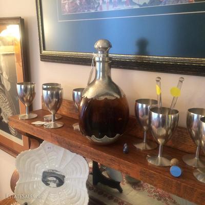 Pinched brown glass decanter with Pewter. Also, eight pewter drinking glasses