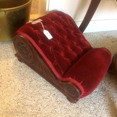 Hand carved mahogany foot rest with a red mohair upholstery