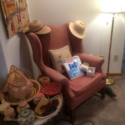 Collection of woven African baskets and a wing back chair