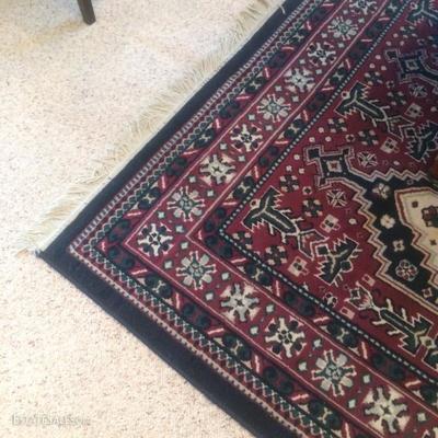 Machine made area rug. Approx. 5'x7'. Unusual colors and in good condition.