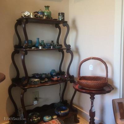 Delicate curved shelf made of solid dark stained wood hosting a large collection of cloisonnÃ© objects