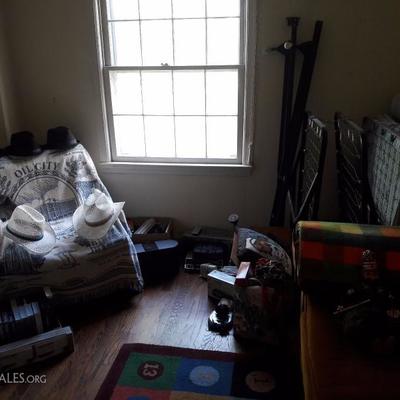 Electronics, men's hats and clothing, tools, twin bed frame, collectibles, blankets, rug, loveseat, leather chair, twin roll away bed...