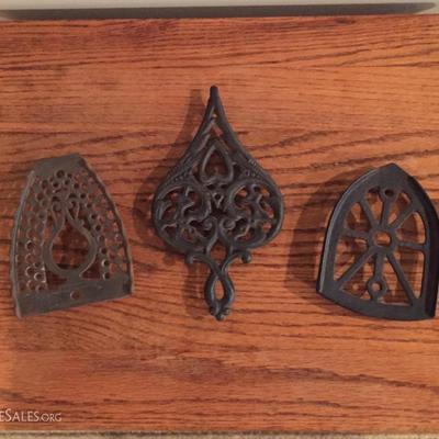Cast iron trivet and two iron rests