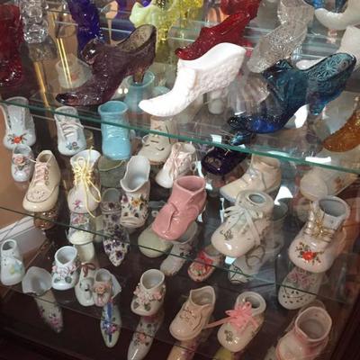 Large collection of porcelain and ceramic shoes.