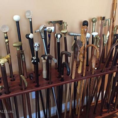 Large collection of handmade wooden canes.
