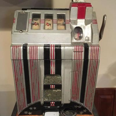 Vintage nickel slot machine (works!) and stand.
