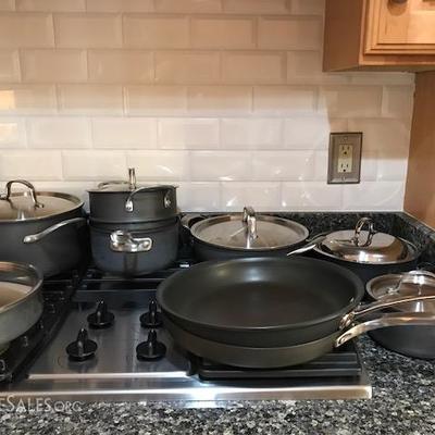 Large collection of Calphalon pots and pans.