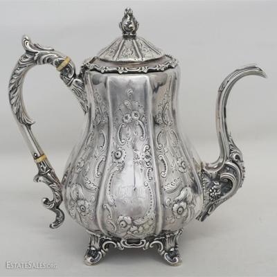 Southern Coin Silver Tea Pot, c. 1849, elaborately decorated paneled body, scroll handle, feet and finial, floral repousse decoration....