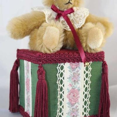 Music Box Bear-201.  Jester Bear with white lace  ruffle threaded with burgundy ribbon bow and  bells.  Sits on green satin and burgundy...