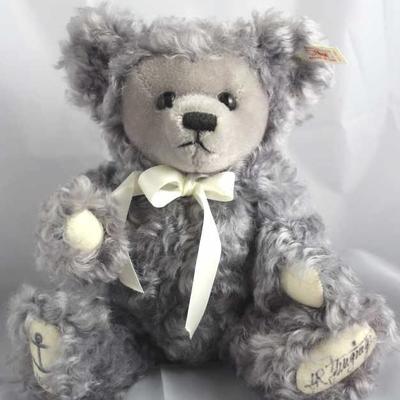 Sea Bear-703 Gray Bear.  WDW-1988 Teddy Bear and  Doll Convention.  Has a shaved face with a cream  ribbon neck bow.  On the bottom of...