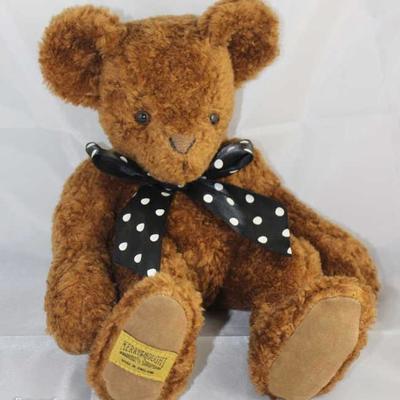 Curly Bean Bear-98, Merrythought-England.  Bear in  lamb (distressed persian) brown.  Trademark tag  across bottom pad.  Jtd. brown bear...